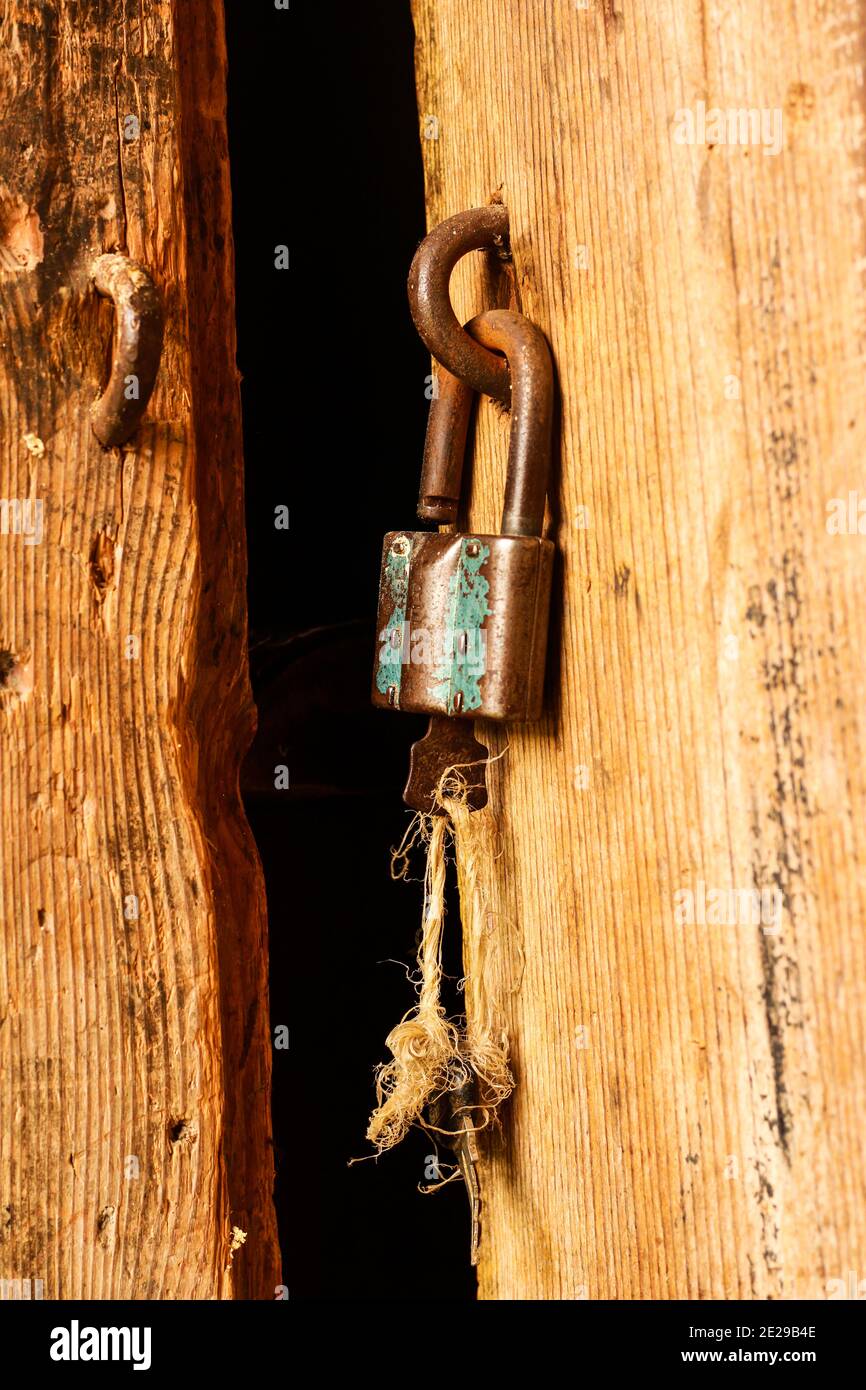 Vertical shot of an old and rusted lock on a wooden door Stock Photo ...