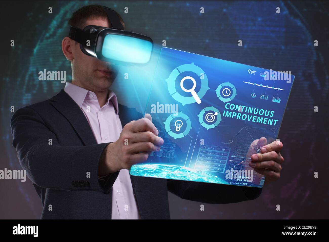 Business, Technology, Internet and network concept. Young businessman working in virtual reality glasses sees the inscription: Continuous improvement Stock Photo