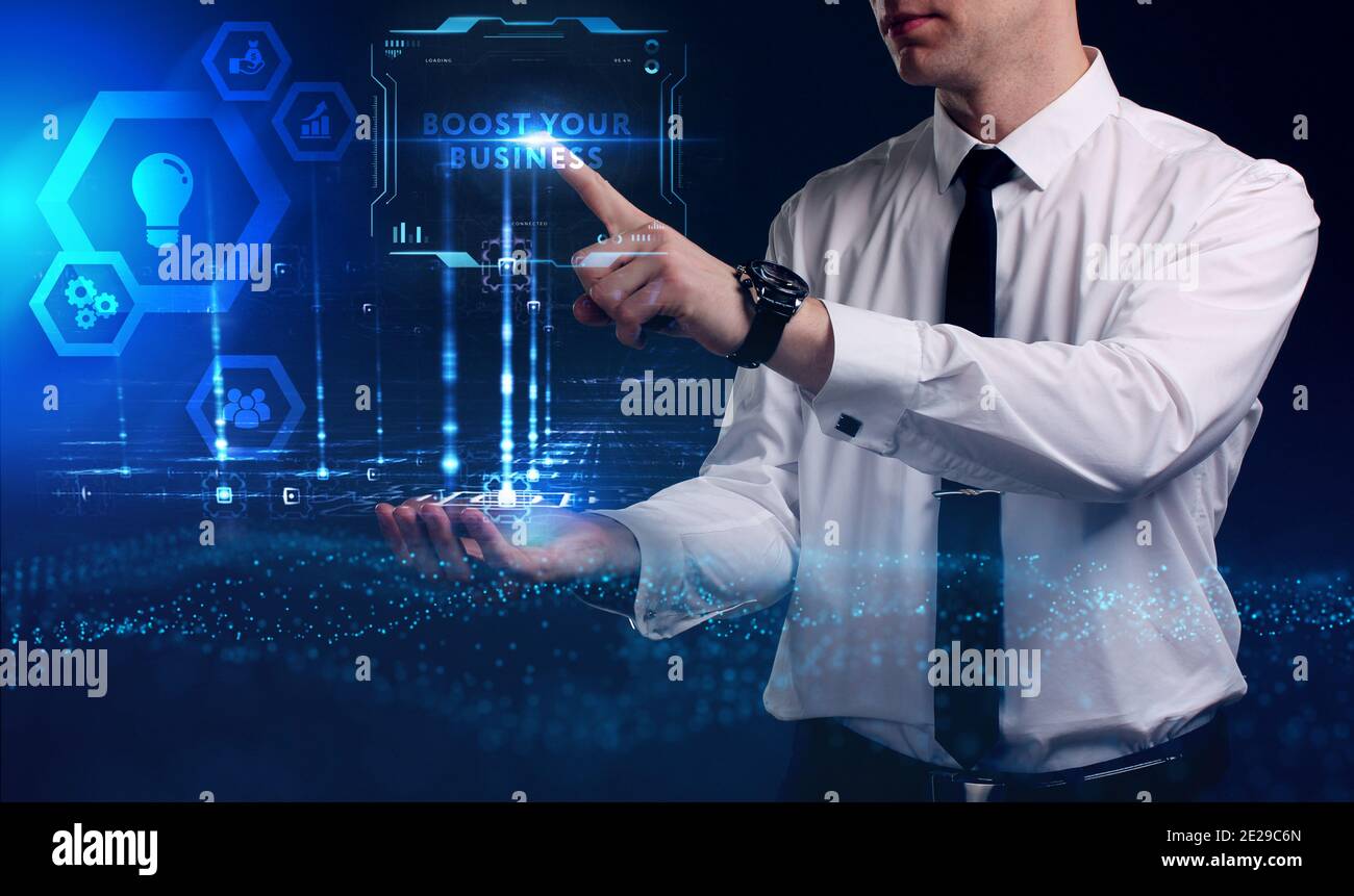 Business, Technology, Internet and network concept. Young businessman working on a virtual screen of the future and sees the inscription: Boost your b Stock Photo