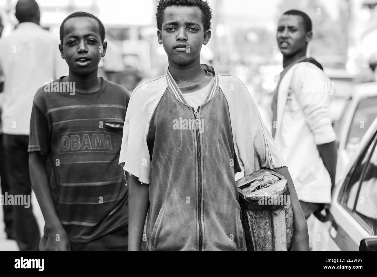 ADDIS ABABA, ETHIOPIA - Jan 05, 2021: Addis Ababa, Ethiopia, January 27, 2014, Children working as shoe shine boys on the street, looking straight at Stock Photo