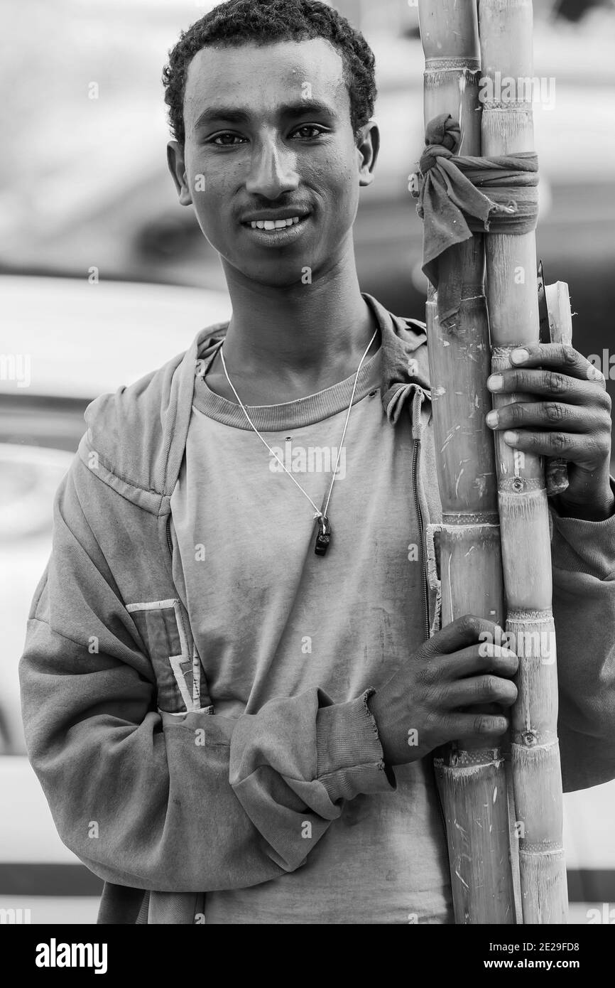 ADDIS ABABA, ETHIOPIA - Jan 05, 2021: Addis Ababa, Ethiopia, January 27, 2014, Man selling sugarcane on the street Stock Photo
