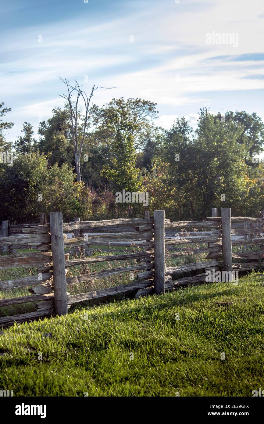 Old fence around a rural grass field Stock Photo