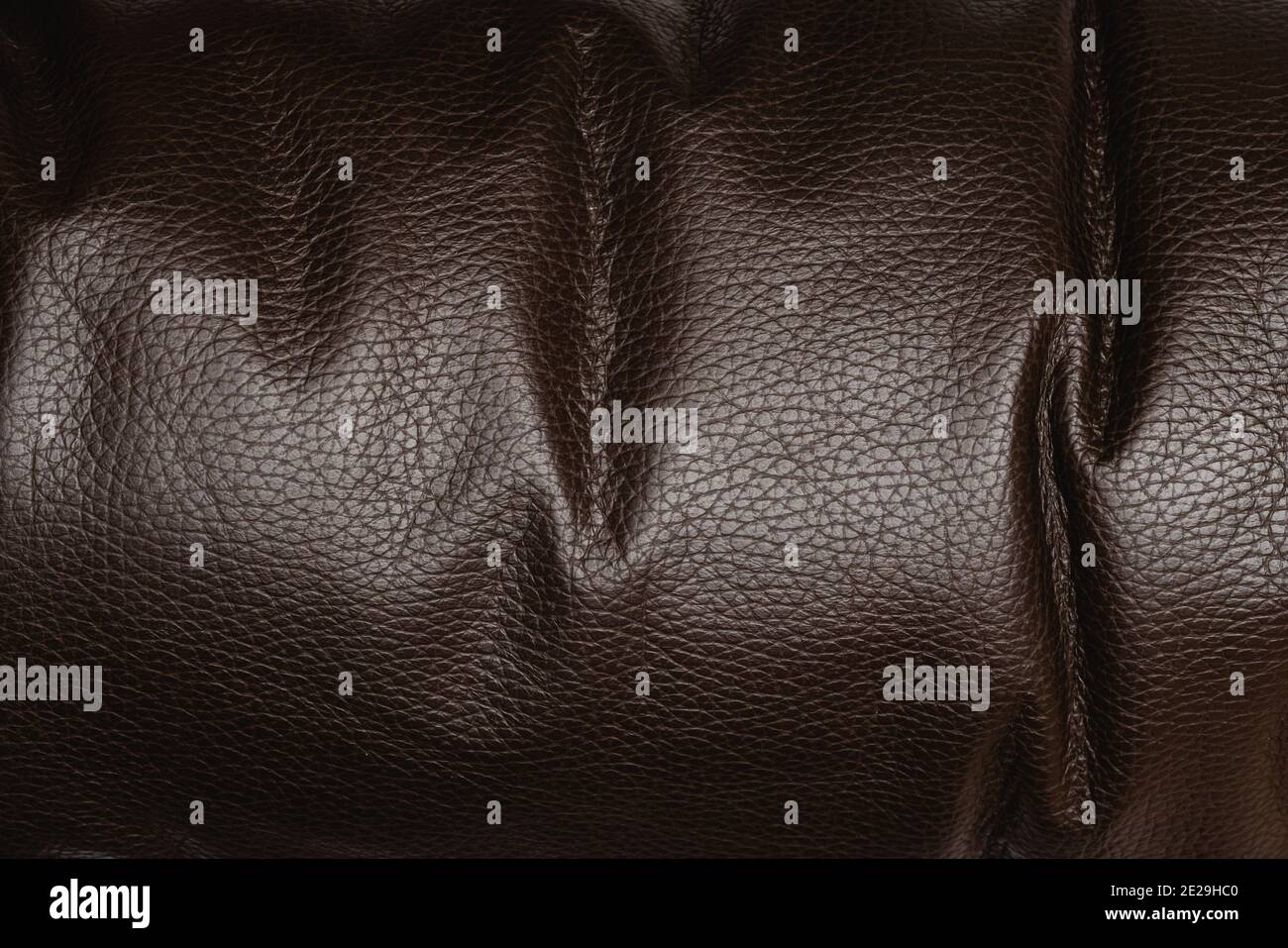 Dark brown shiny leather textured background, abstract Stock Photo