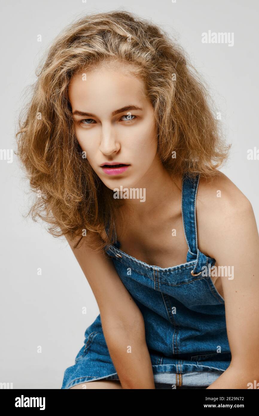 Strict and tense girl looks piercingly from under the forehead Stock Photo
