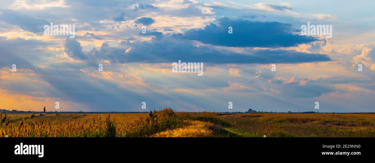 Dramatic cloudscape area landscape with rays of light. Stock Photo