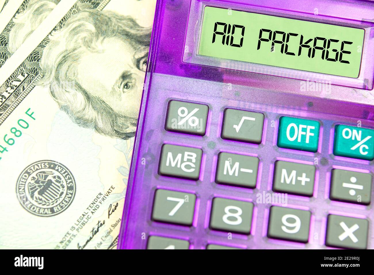 Dollar bills, calculator and aid package for the US economy Stock Photo
