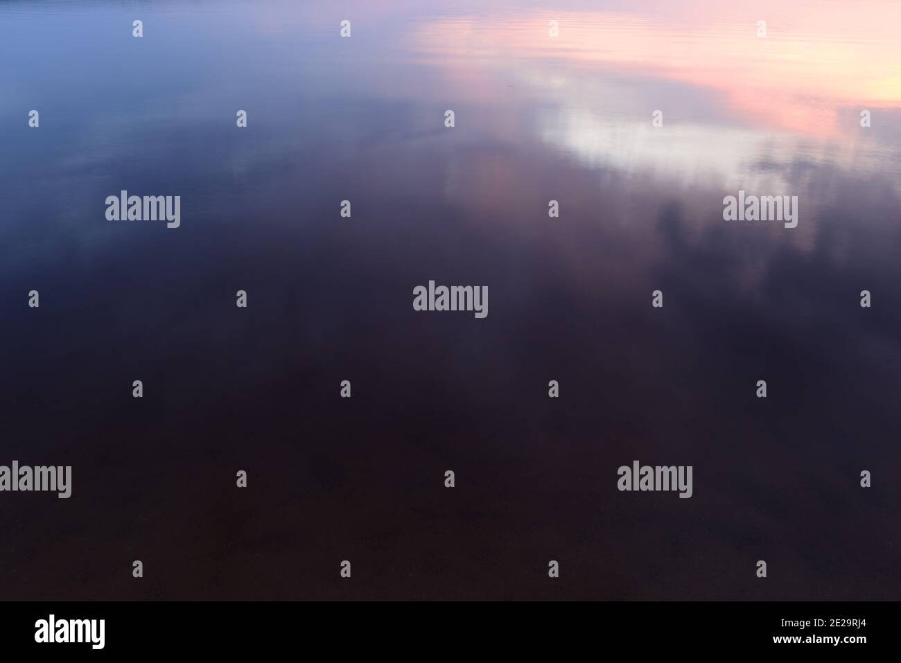 Lake water with light reflection at sunset Stock Photo - Alamy