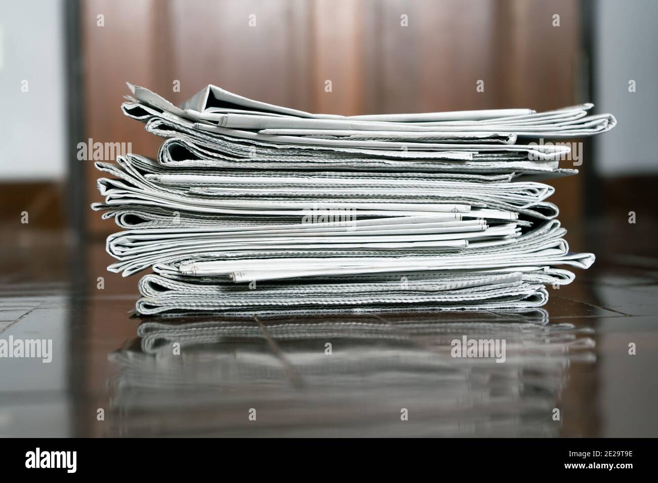 A pile of newspaper on the floor Stock Photo