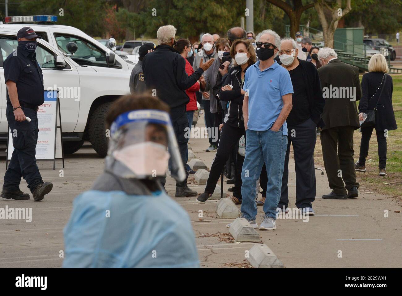 Los Angeles, California, USA. 13th Jan, 2021. Los Angeles, United States. 13th Jan, 2021. Residents wait in line to be inoculated with the Moderna COVID-19 vaccine at the Balboa Sports Center vaccination site in Los Angeles on Tuesday, January 12, 2021. People aged 65 and older and those with serious underlying health conditions in Los Angeles and across California could quickly become eligible for a COVID-19 vaccine, with federal officials urging states Tuesday to more widely distribute the shots. Photo by Jim Ruymen/UPI Credit: UPI/Alamy Live News Credit: UPI/Alamy Live News Stock Photo
