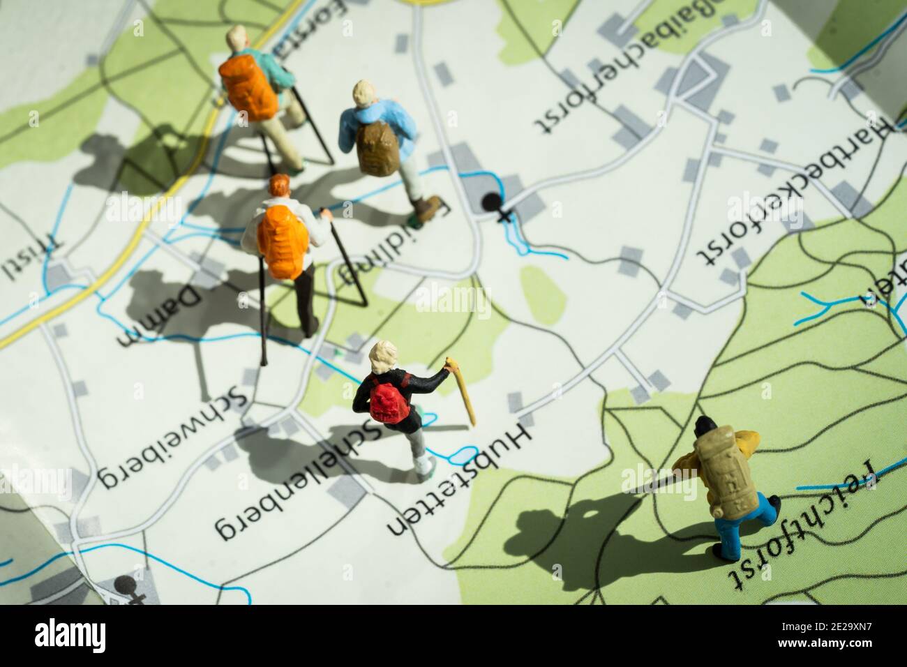 Figurines of backbackers walking over a hiking map Stock Photo