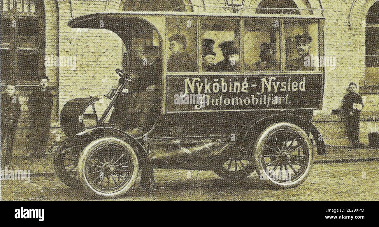 Vintage black and white photograph with the caption Danmarks første rutebil/the first bus 1903. Early public transport in Denmark. Stock Photo