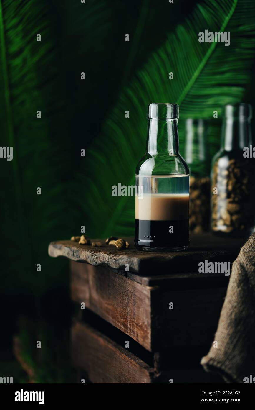 B-52 - layered cocktail with three liqueurs Kahlua, Baileys, Cointreau served in a small bottle. Stock Photo