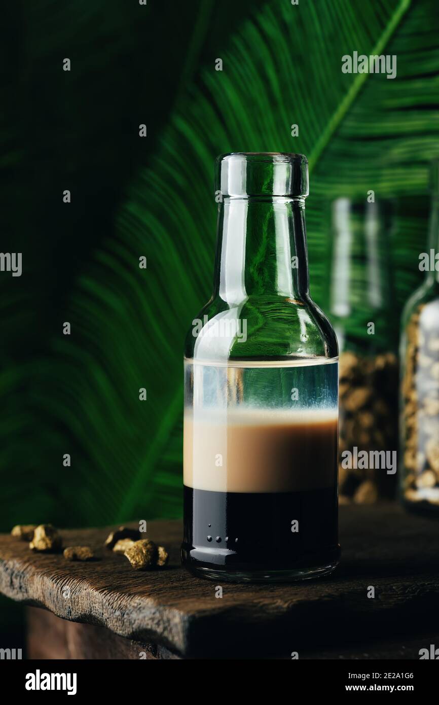 B-52 - layered cocktail with three liqueurs Kahlua, Baileys, Cointreau served in a small bottle. Stock Photo