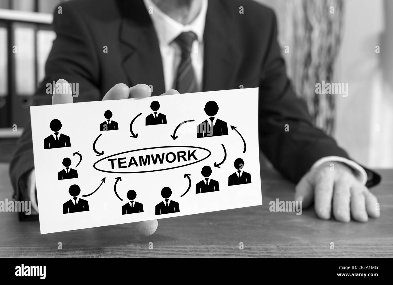 Businessman showing an index card with teamwork concept Stock Photo Alamy