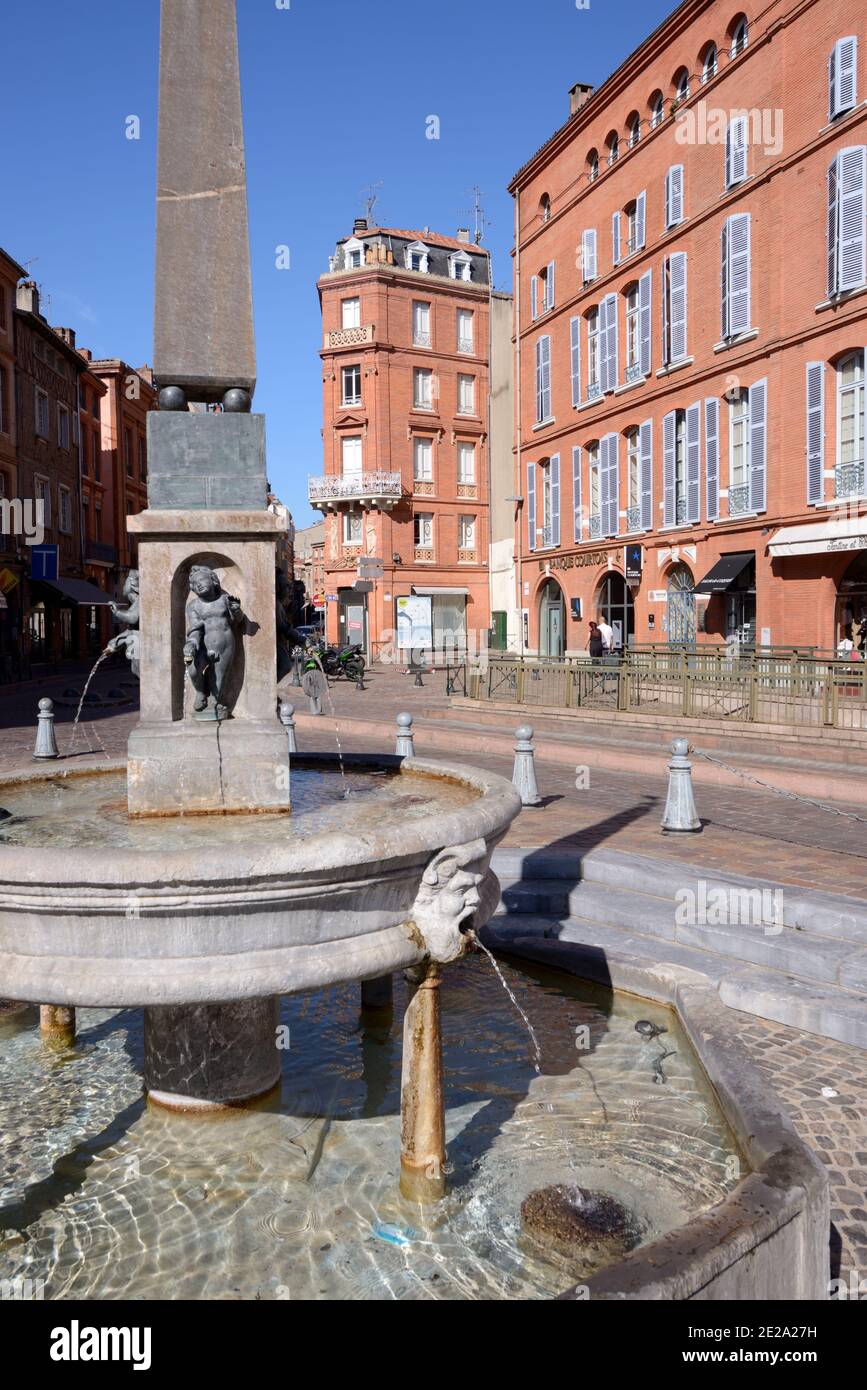 Fontaine Saint Etienne (1547-1549) or Street Fountain & Obelisk in Place Etienne Town Square & Historic Brick Architecture Toulouse France Stock Photo