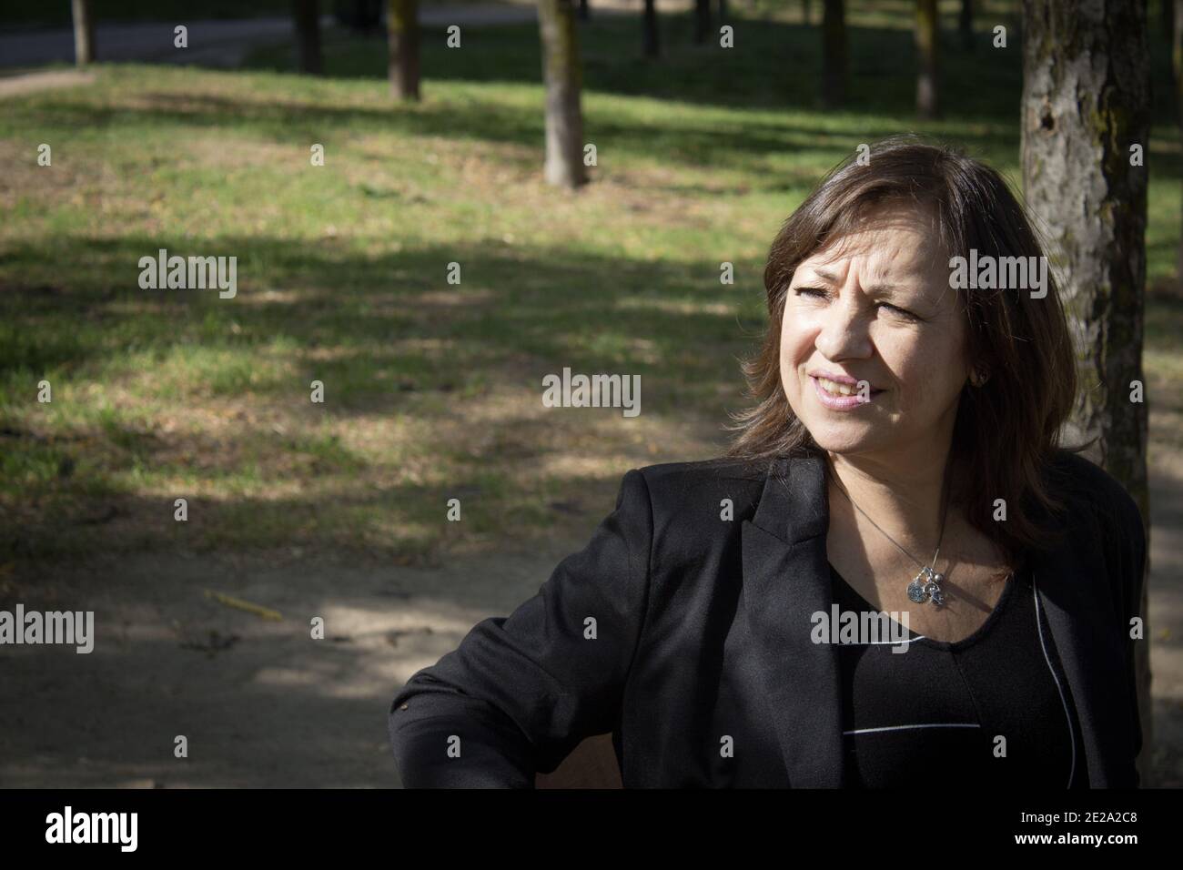 Mature woman in positive attitude sitting and standing Stock Photo - Alamy
