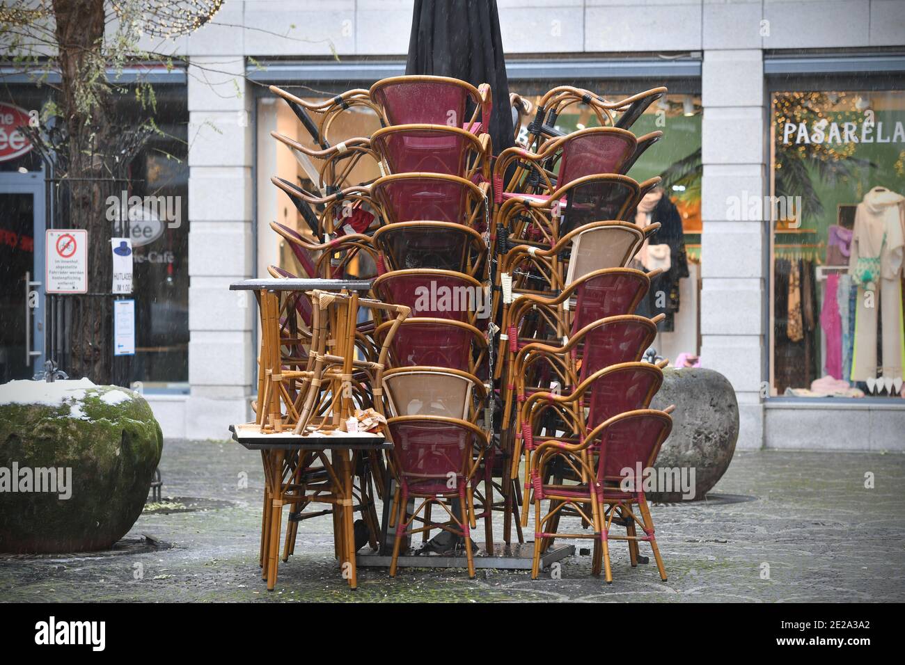 Munich, Deutschland. 12th Jan, 2021. Topic picture: Coronavirus pandemic/consequences for gastronomy: stacked chairs and tables in the outdoor area of a restaurant in Munich on January 12th, 2021. | usage worldwide Credit: dpa/Alamy Live News Stock Photo