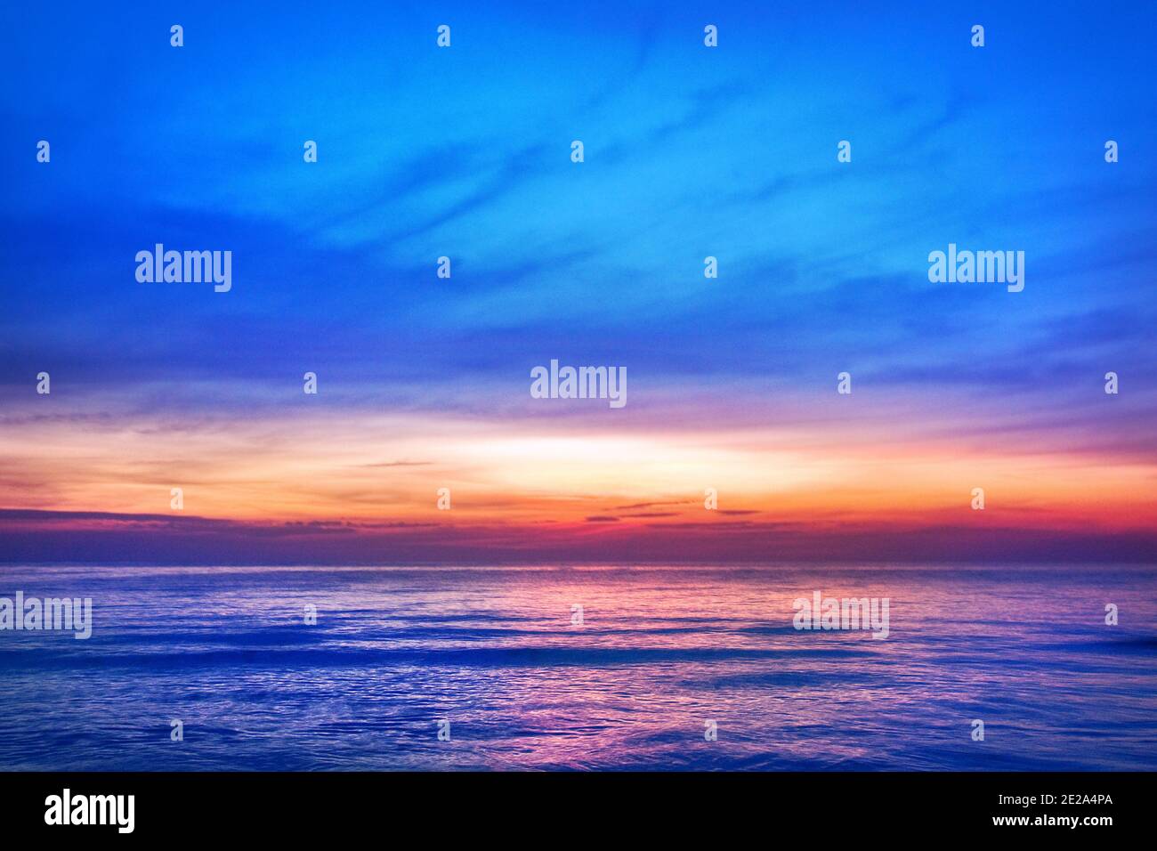 Beautiful pink sunset, blue sky, purple sea background, blurred