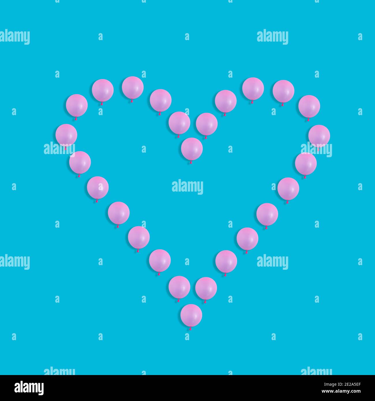 Heart shape from pink balloons isolated on a blue background Stock ...