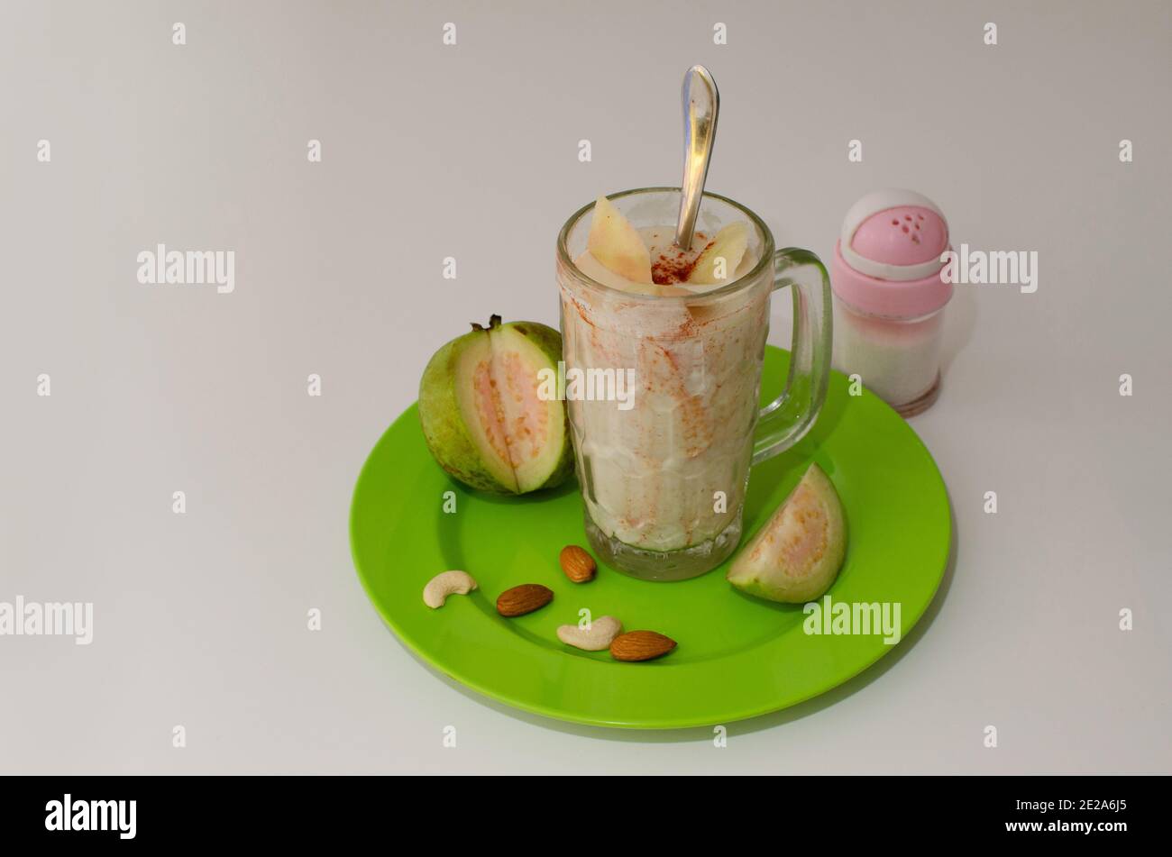 Guava or Peru Milk Shake with red chilli powder sprinkled over the shake, Top angle view, Studio Shot Stock Photo