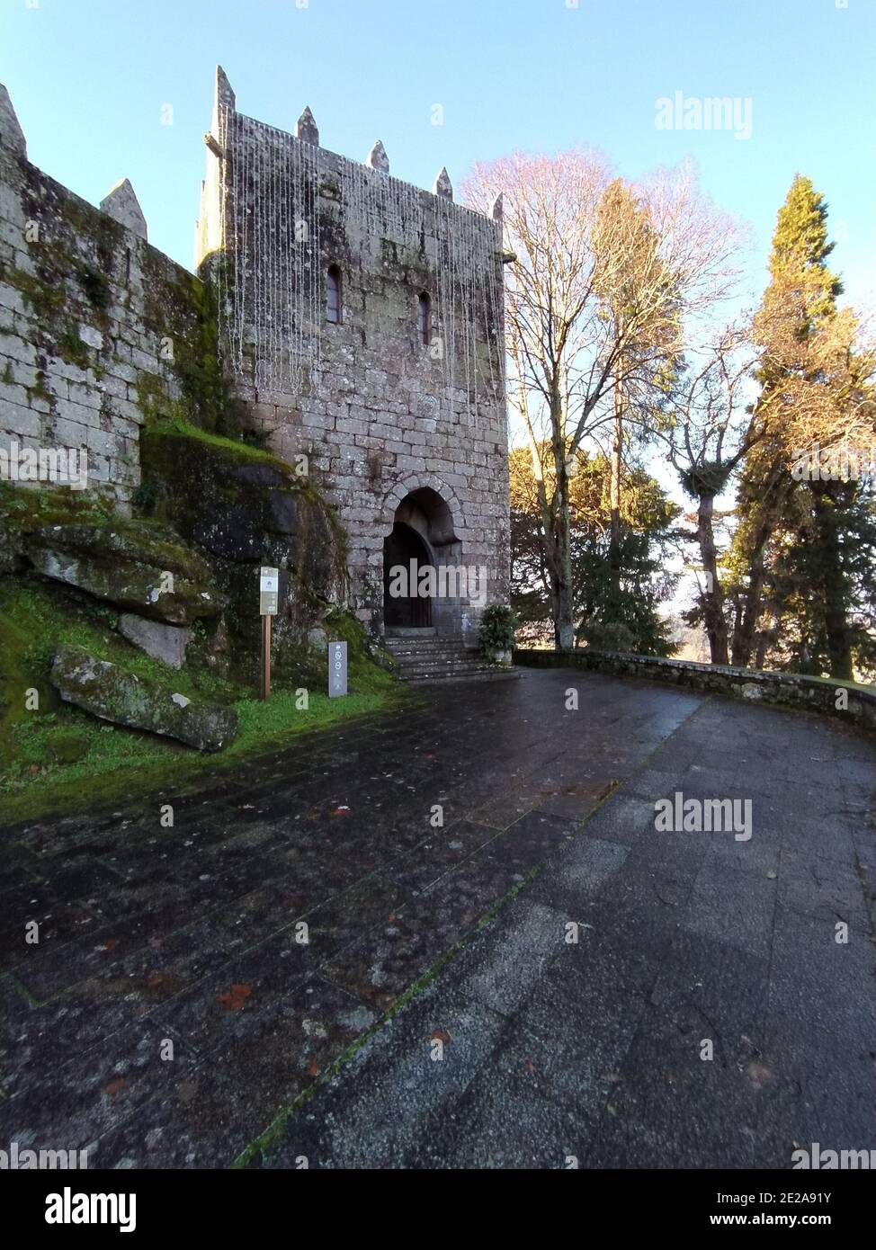 Vertical shot of a stone building in a garden in the daytime under the ...