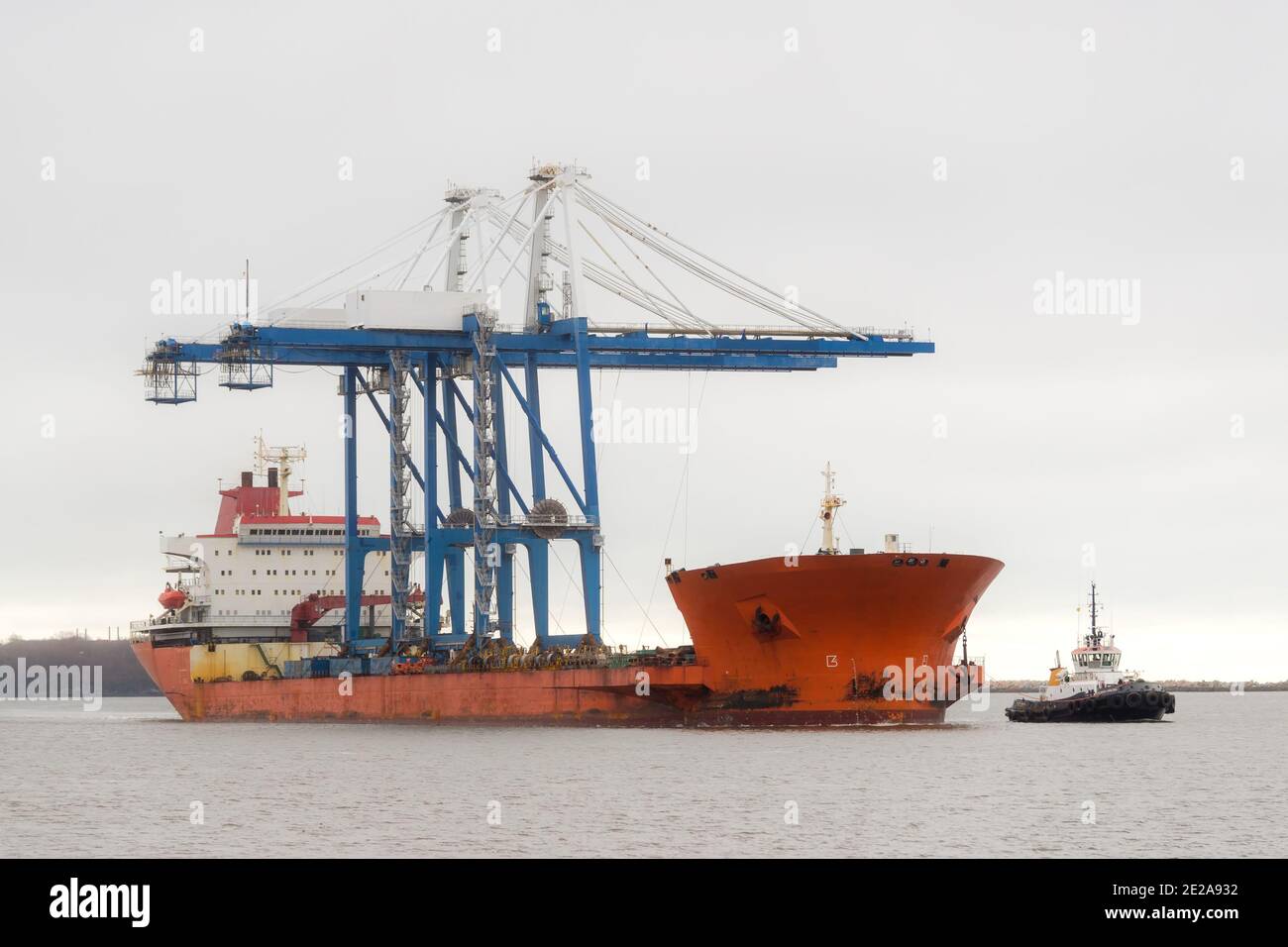 Ship carrying two large cranes. Cranes are the type used for shipping