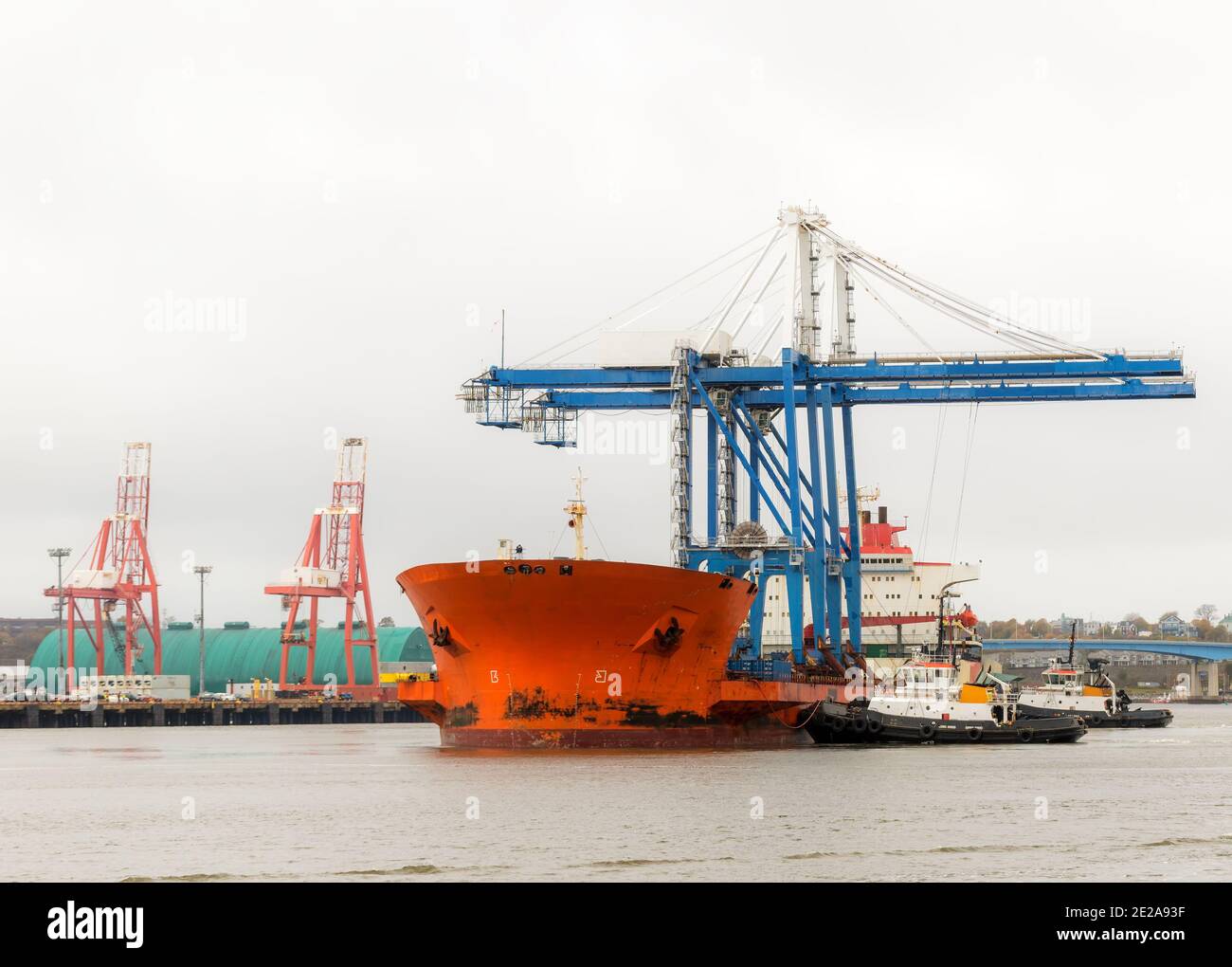 Ship carrying two large cranes. Cranes are the type used for shipping