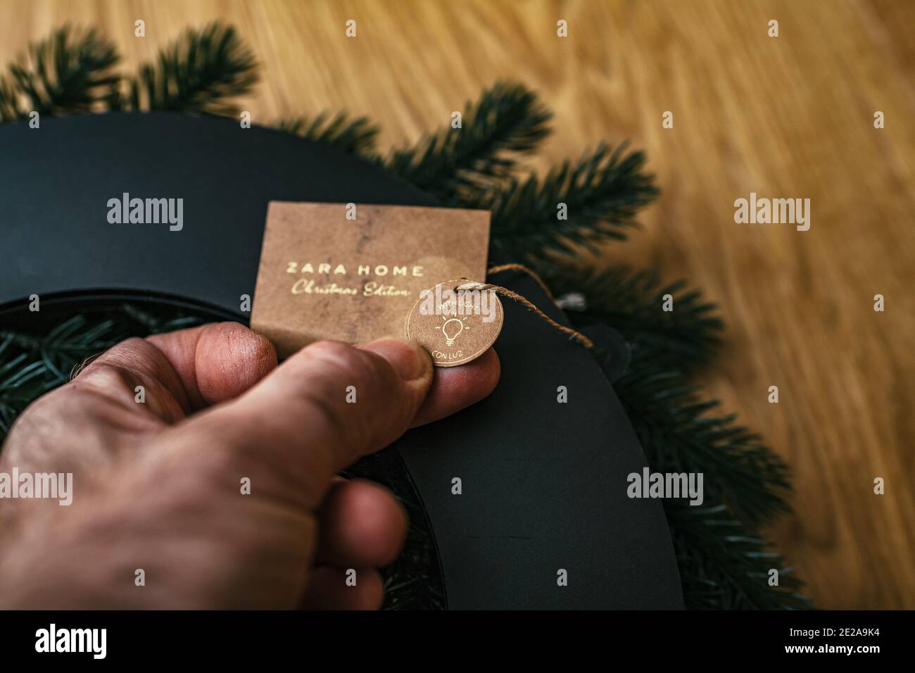 Paris, France - Dec 13, 2020: POV male hand holding Zara home Christmas  Edition price tag with light metnion on the recycled paper on a decorative  wreath for home Stock Photo - Alamy