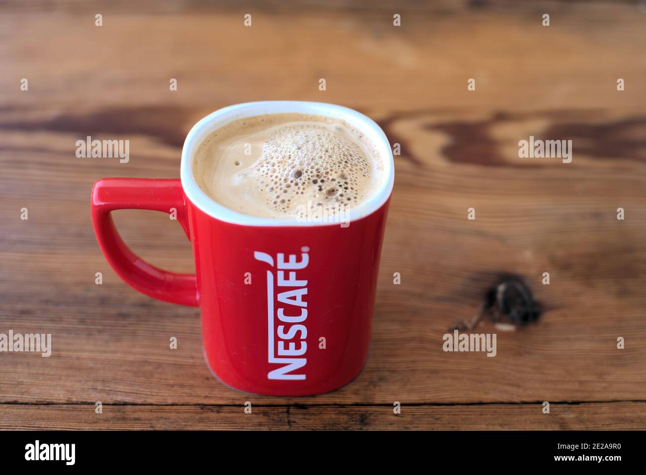 https://c8.alamy.com/comp/2E2A9R0/volos-greece-jan-08-2021-nescafe-red-cup-mug-coffee-12-oz-red-printed-white-logo-ceramic-filled-with-hot-coffee-2E2A9R0.jpg