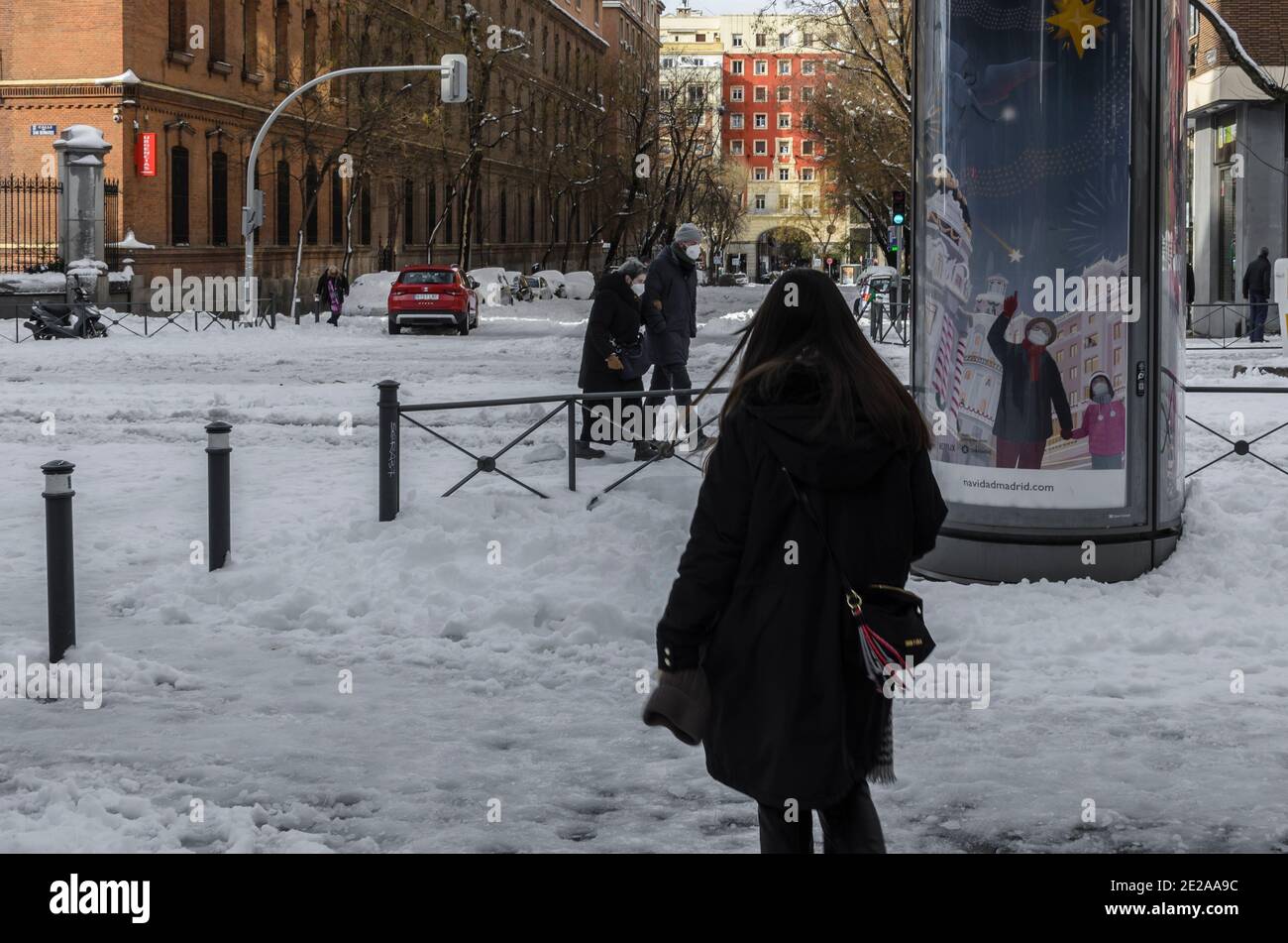 Madrid, Spain. 10 th January 2021. View of a woman in San Bernardo street after storm snow. Credit: Enrique Davó. Stock Photo