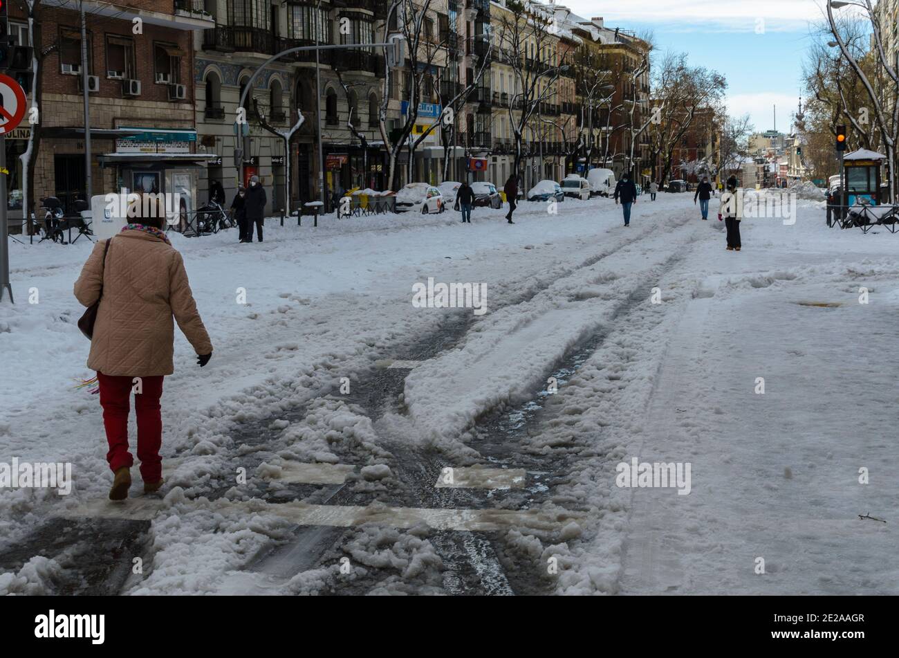 Madrid, Spain. 10 th January 2021. View of a woman in San Bernardo street after the storm snow. Credit: Enrique Davó. Stock Photo