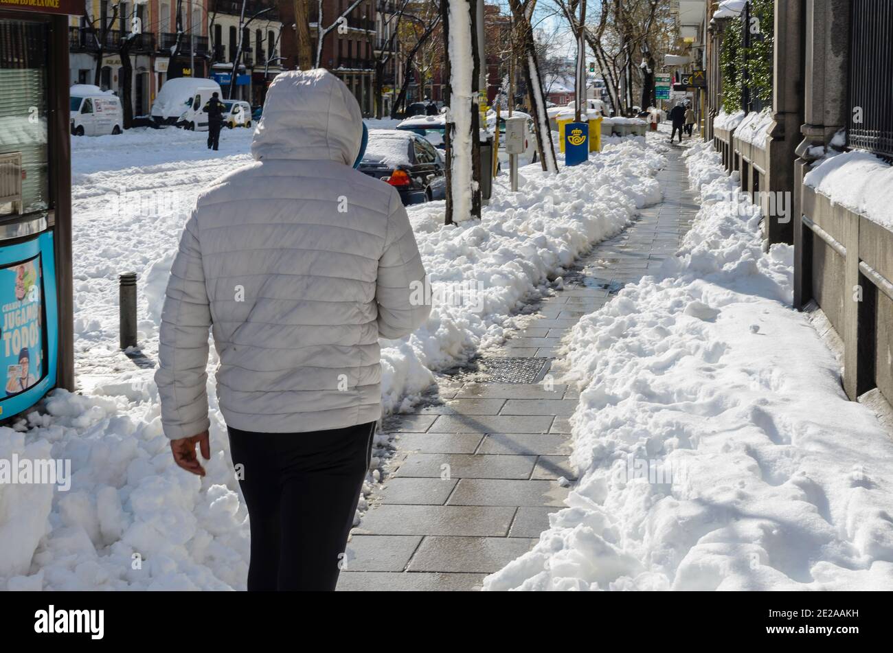 Madrid, Spain. 10 th January 2021. View of a man in San Bernardo street after storm snow. Credit: Enrique Davó. Stock Photo