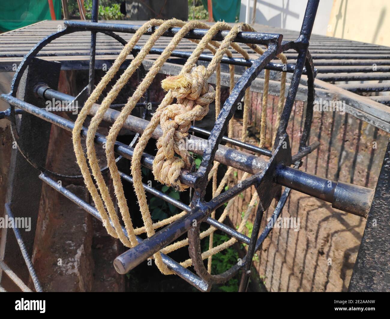 Vintage iron water remover wheel to pull water outside of water well with a rope tied to a