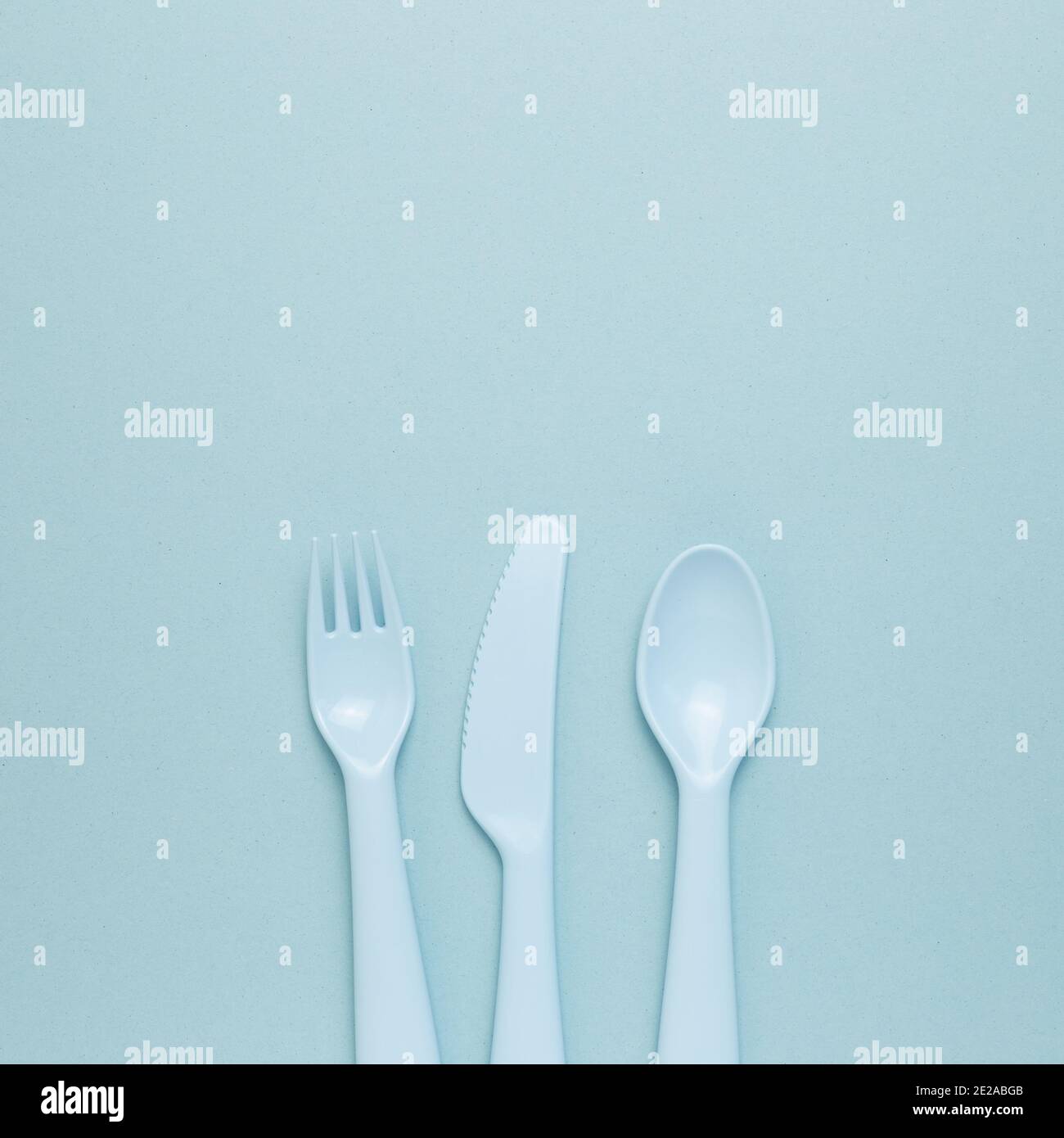 Fork knife spoon on sky blue background. flat lay, top view, copy space Stock Photo