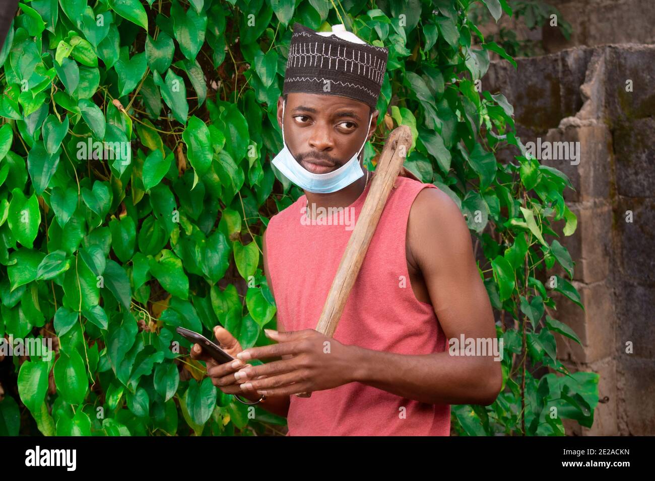 an african farmer in nigeria holding his phone Stock Photo