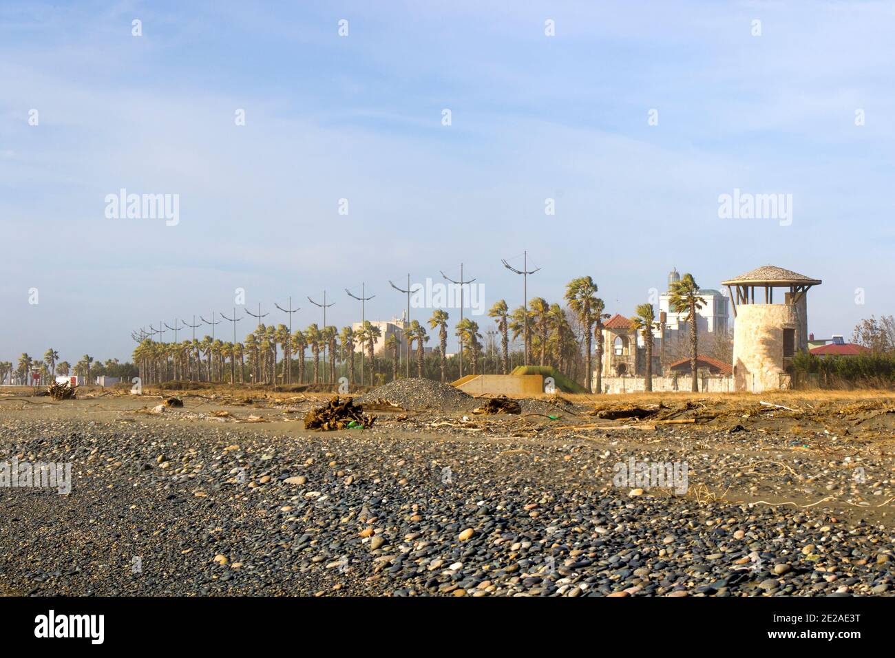 Palm trees and buildings on the beach, black sea Anaklia beach. Stock Photo