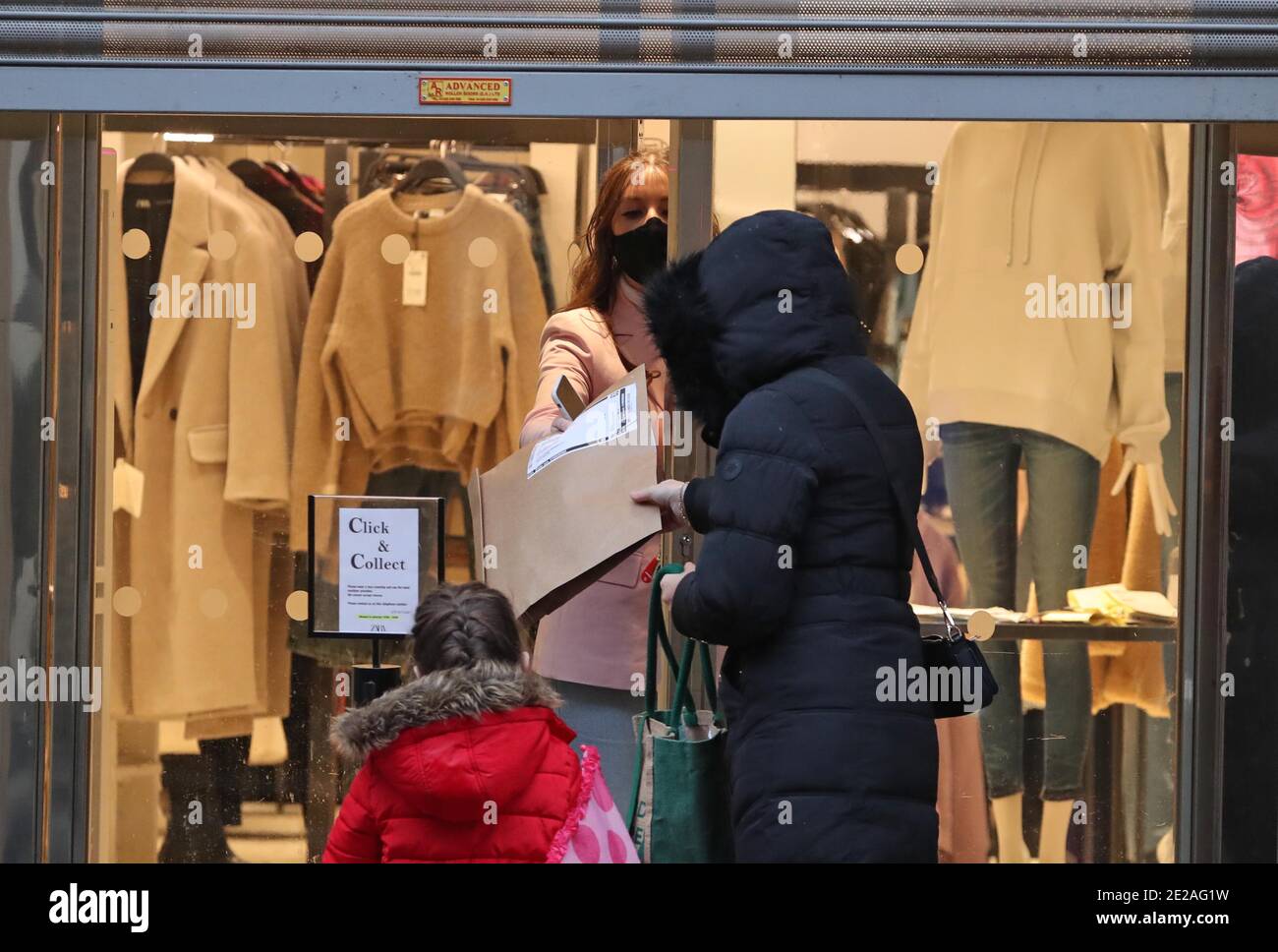 A woman collects a parcel from Zara in Glasgow. Click-and-collect services  will end in Scotland, First Minister Nicola Sturgeon has said, Only  retailers selling essentials, such as clothing, baby equipment and books,