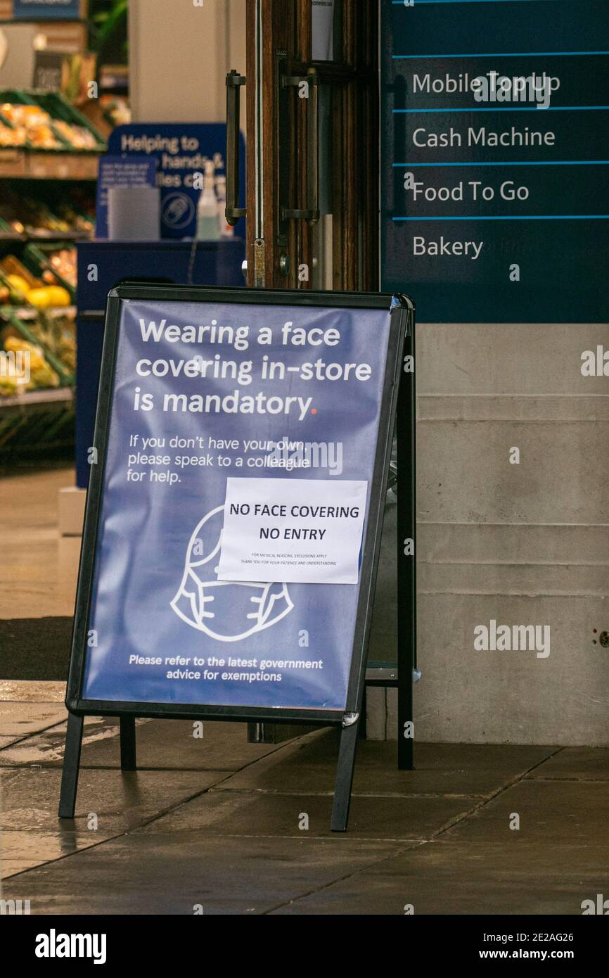 WIMBLEDON LONDON, UK 13 January 2021. A sign reads "No face covering no  entry". outside a Morrisons branch in Wimbledon. British supermarkets  Sainsbury's Morrisons and Tesco have announced they will be enforcing