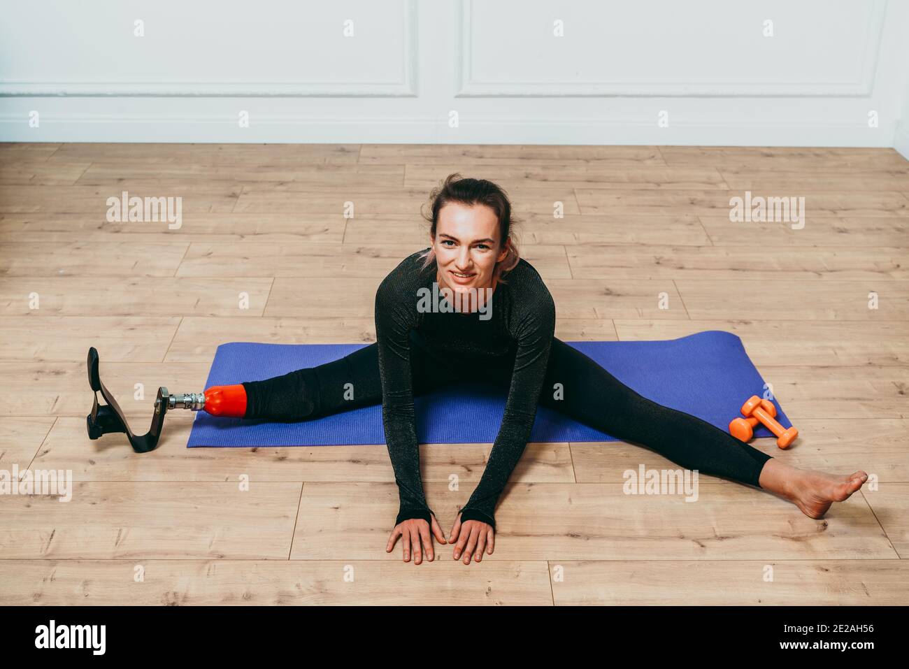 Amputated woman. Cinematic image of a beautiful young woman with leg prosthesis. American veteran showing the war scars. Concept about body positivity Stock Photo