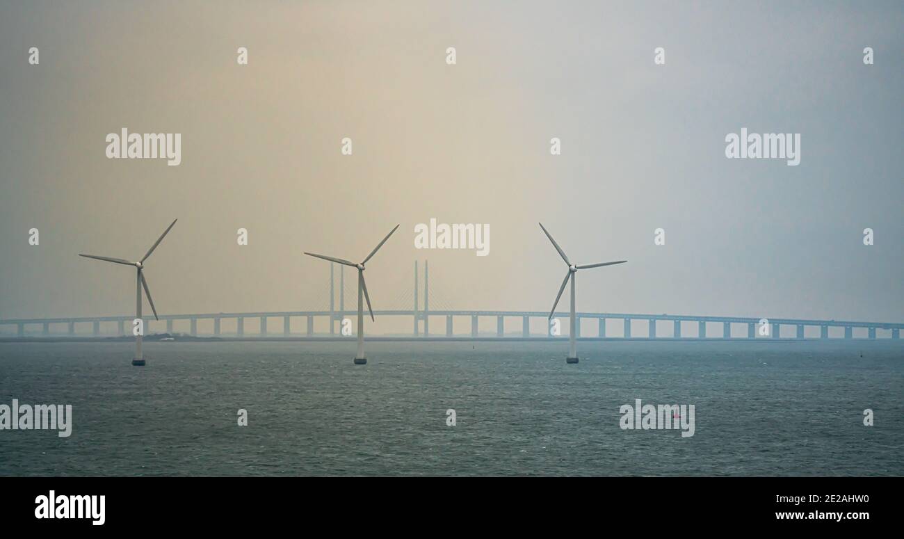 Wind turbines at sea with the Oresund bridge in the background. Stock Photo