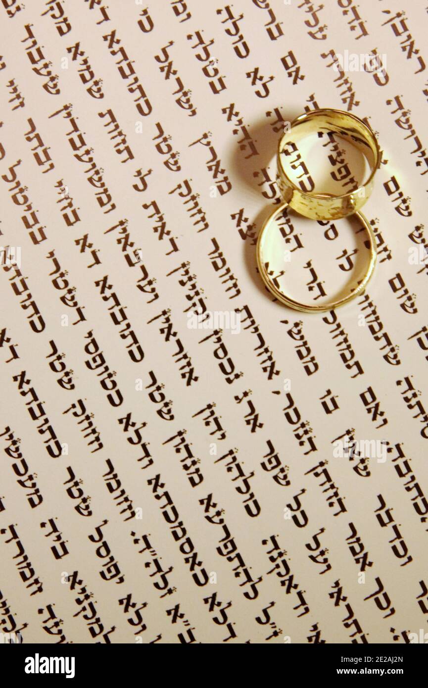Wedding Concept two wedding bands on a Jewish Ktubah Stock Photo