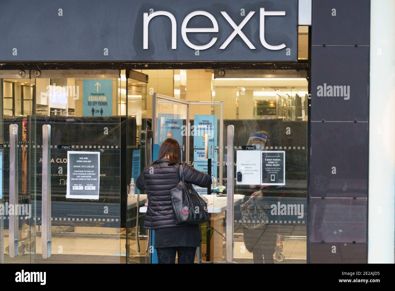 Edinburgh, Scotland, UK. 13 January 2021. Shops in Scotland now generally prohibited from offering Click and Collect service from front doors with some exceptions depending on type of goods on sale. Pic; Next is still open for limited products such as babywear.  Iain Masterton/Alamy Live News Stock Photo