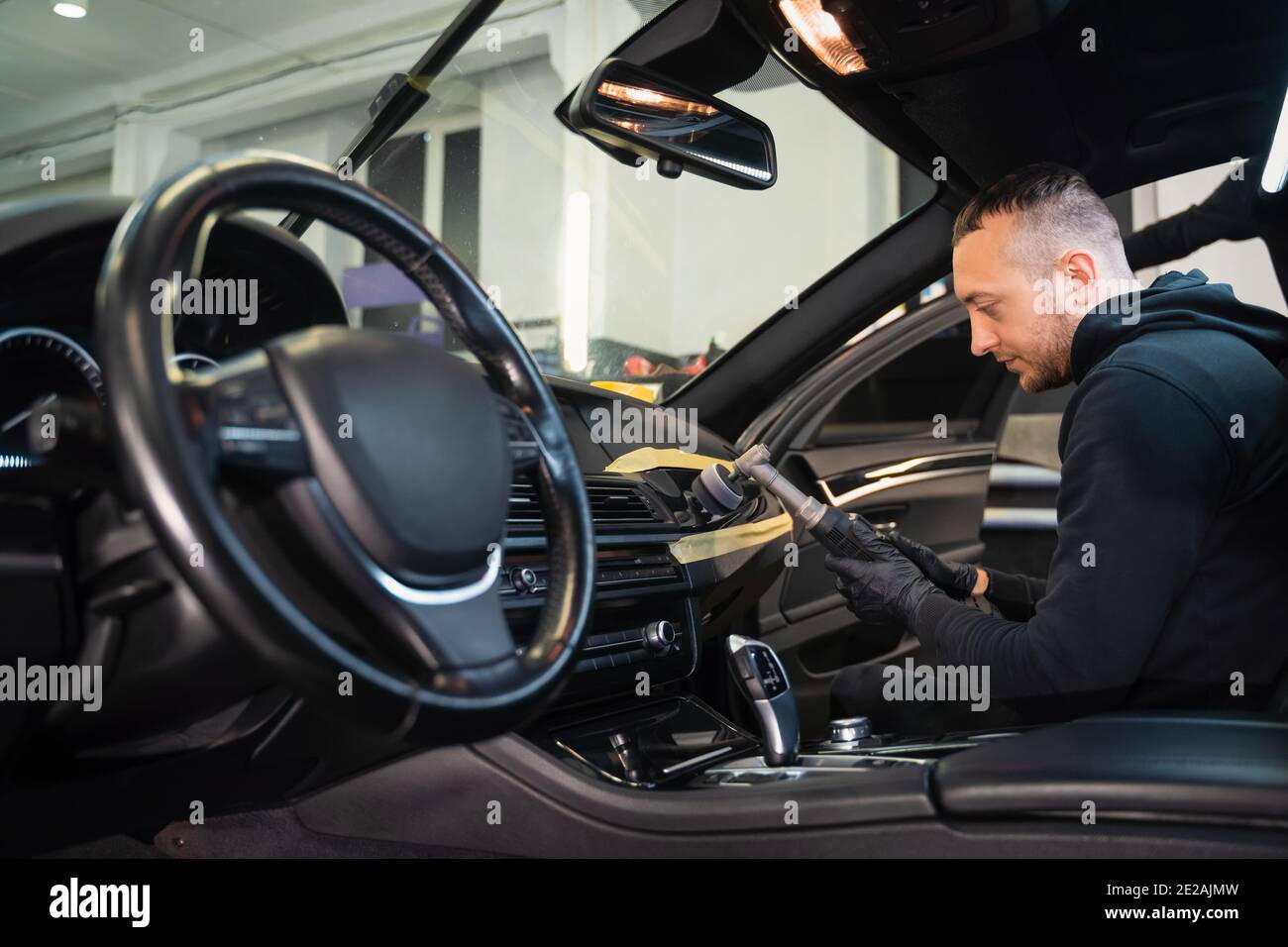 Professional polishing car interior trim. Auto detailing concept Stock