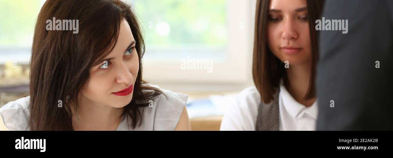 Two female managers discussing working plan with man Stock Photo