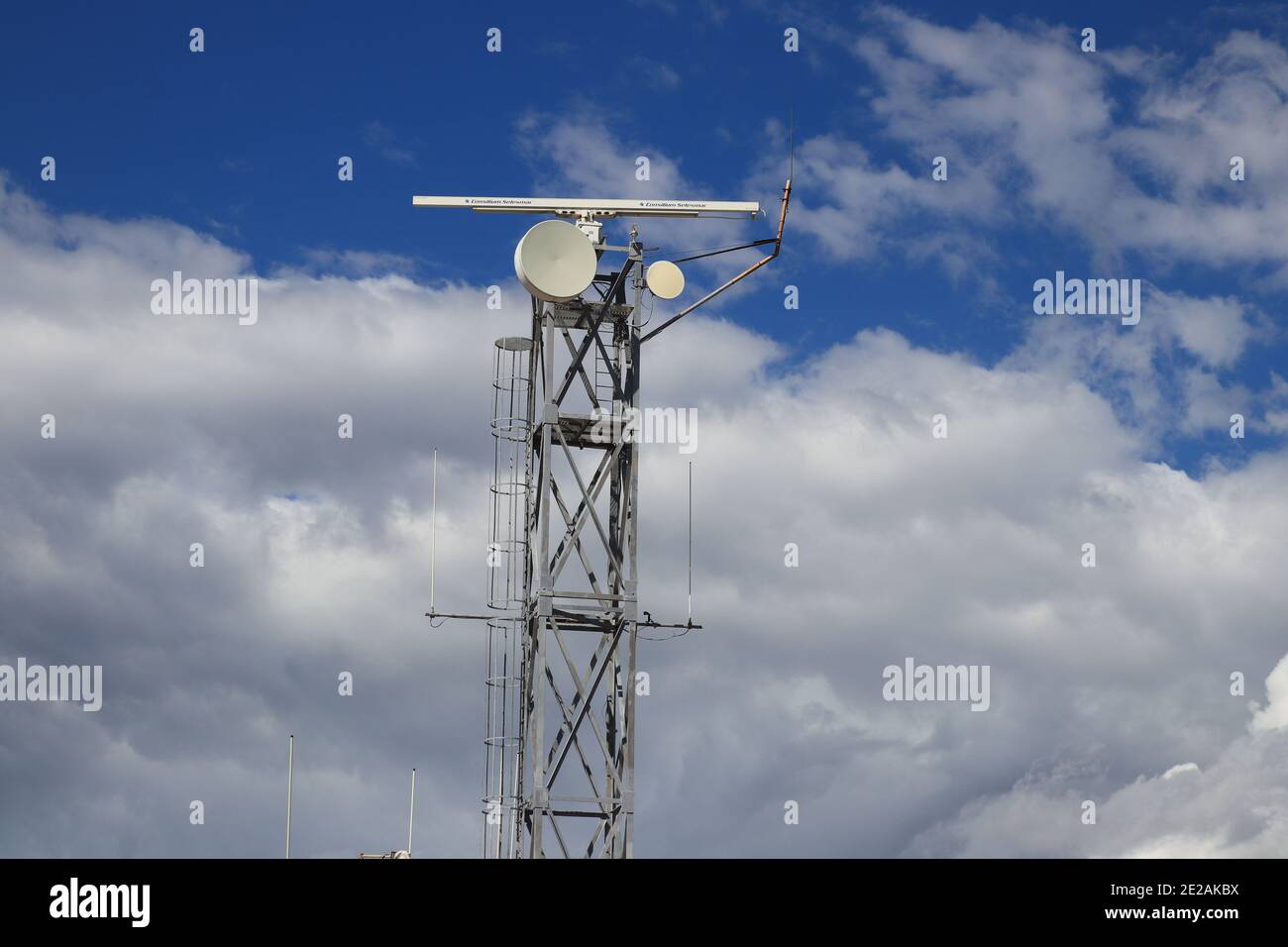 Il-Mellieha, Malta - October 20, 2020: Telecommunication tower against the blue sky with clouds located on the Island of Malta Stock Photo