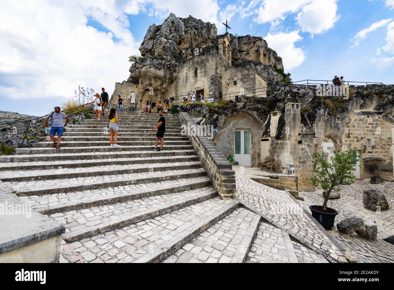 Tourists on the scenic stairway leading to Santa Maria De Idris cave church. Matera, Basilicata, Italy, August 2020 Stock Photo