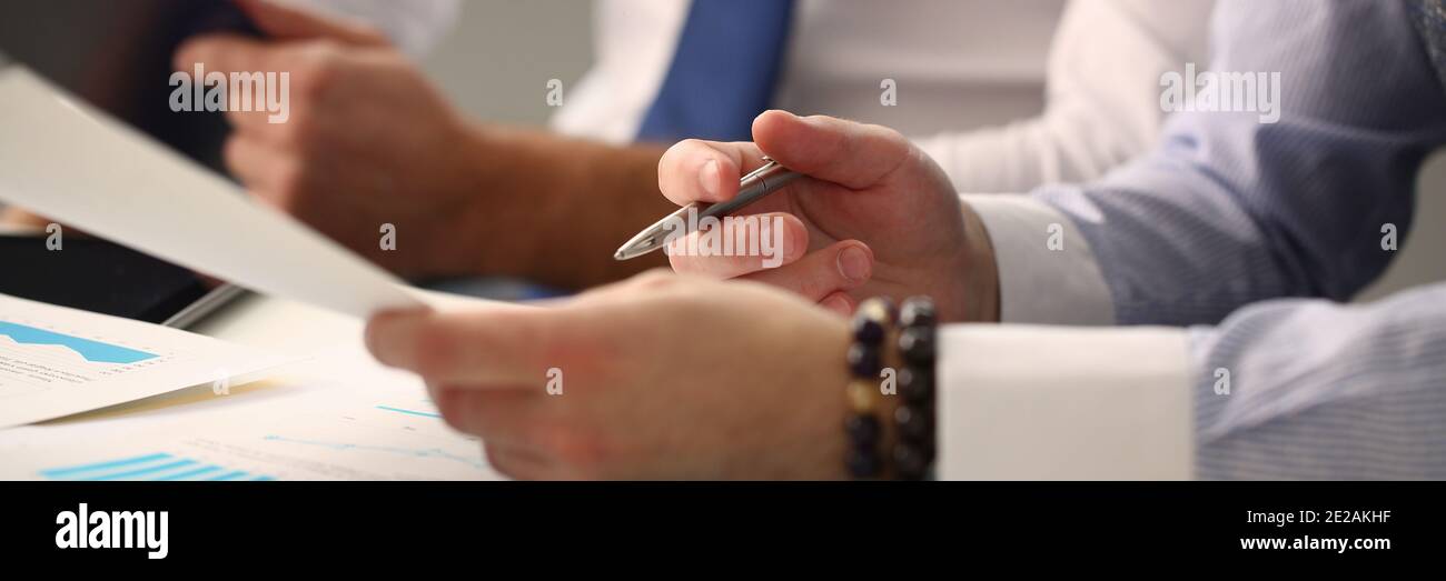 Group of businessmen communicating with financial graph Stock Photo - Alamy