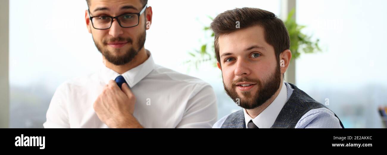Two cheerful managers working in office with touchpad Stock Photo