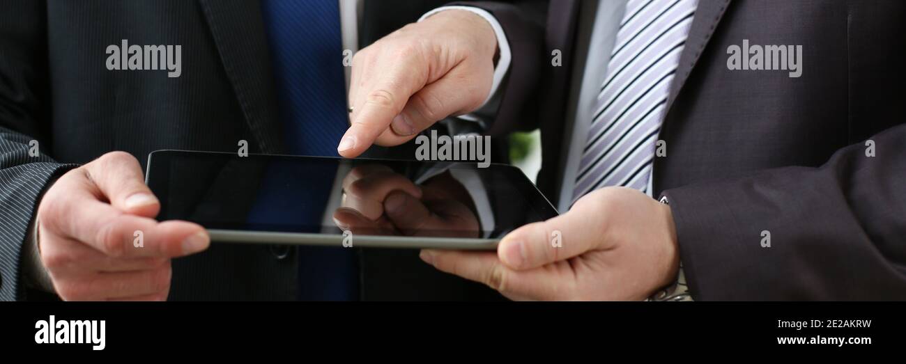 Two businessmen are looking at digital tablet Stock Photo
