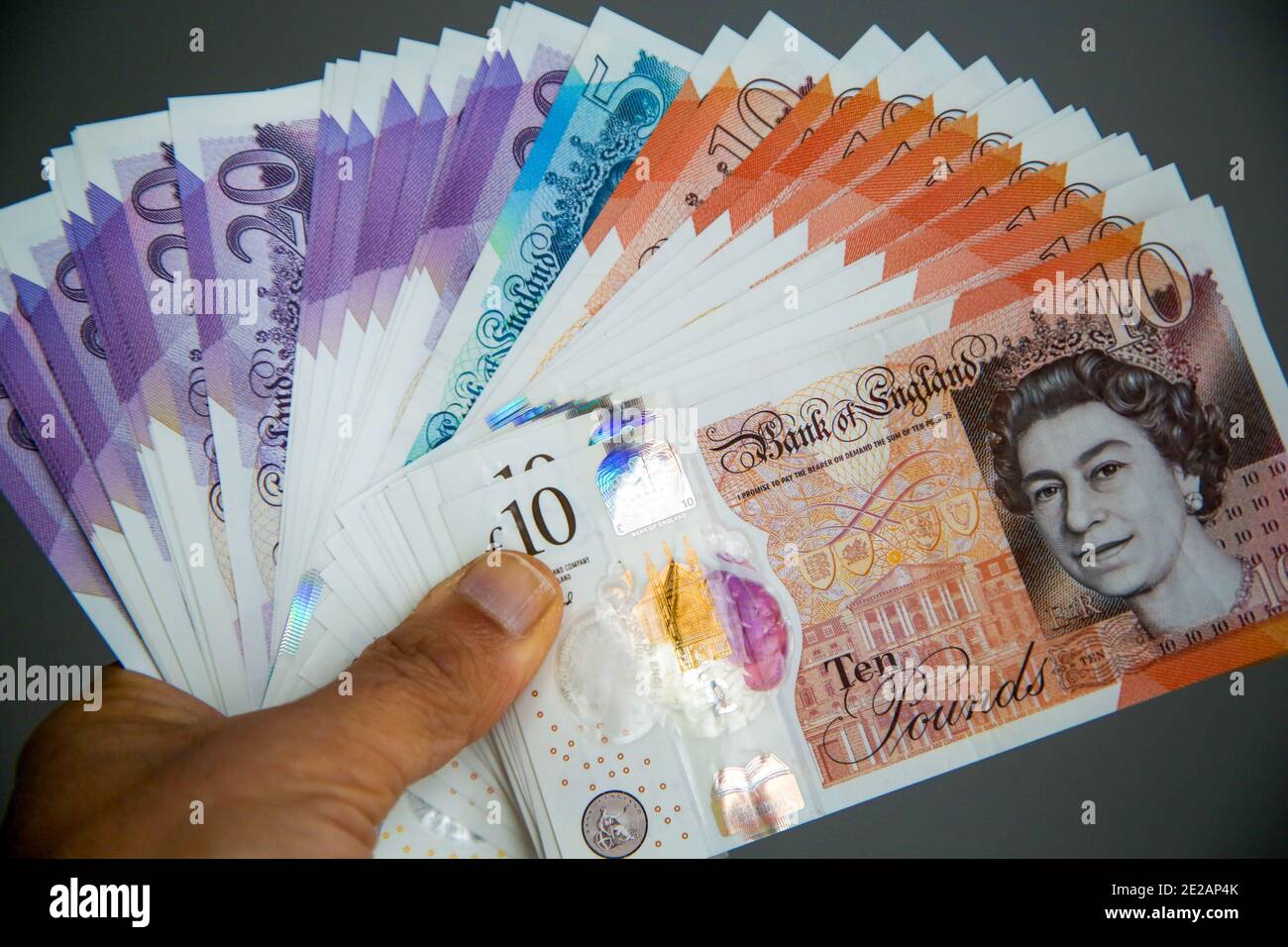 In this photo illustration, a hand holding British twenty, ten and five ...